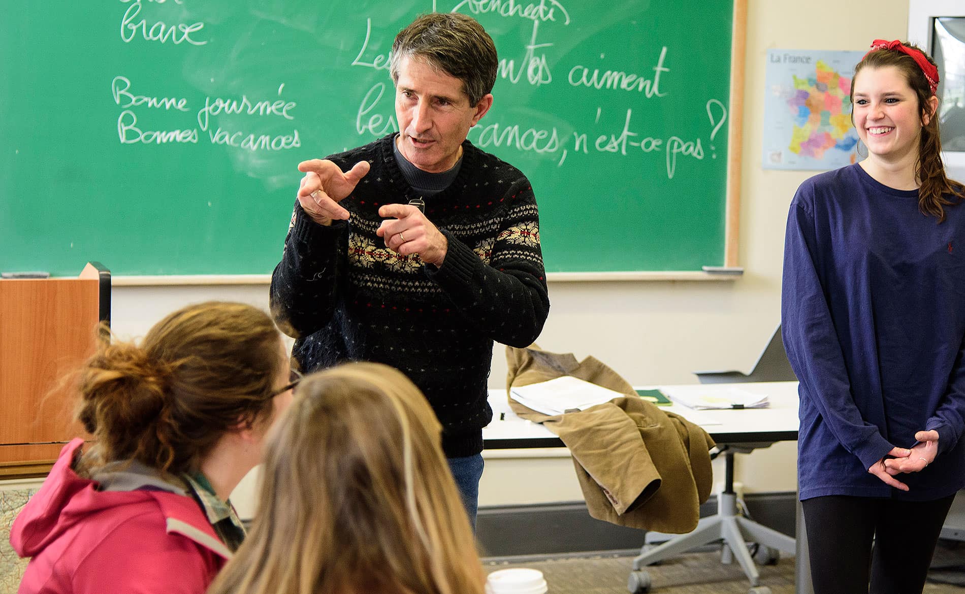 French professor with smiling student