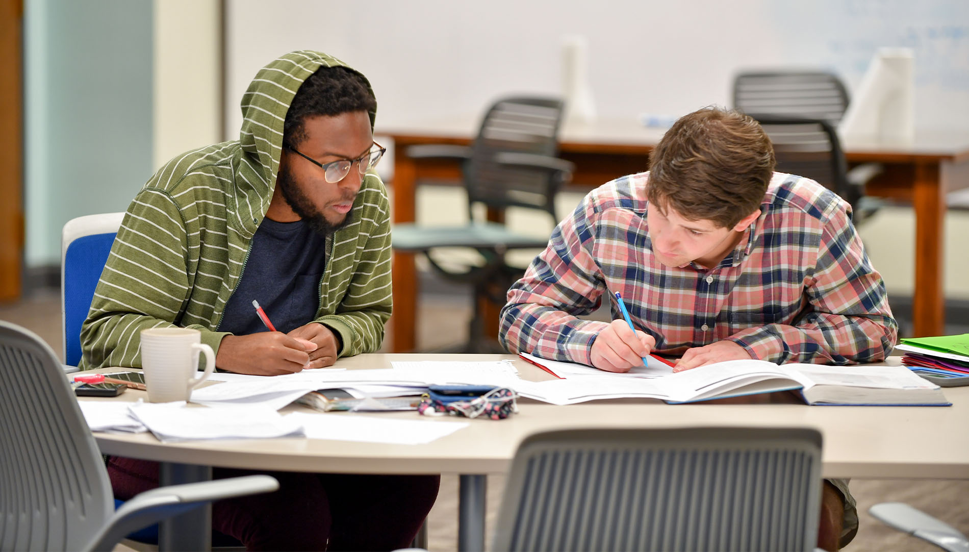 two make students studying and taking notes