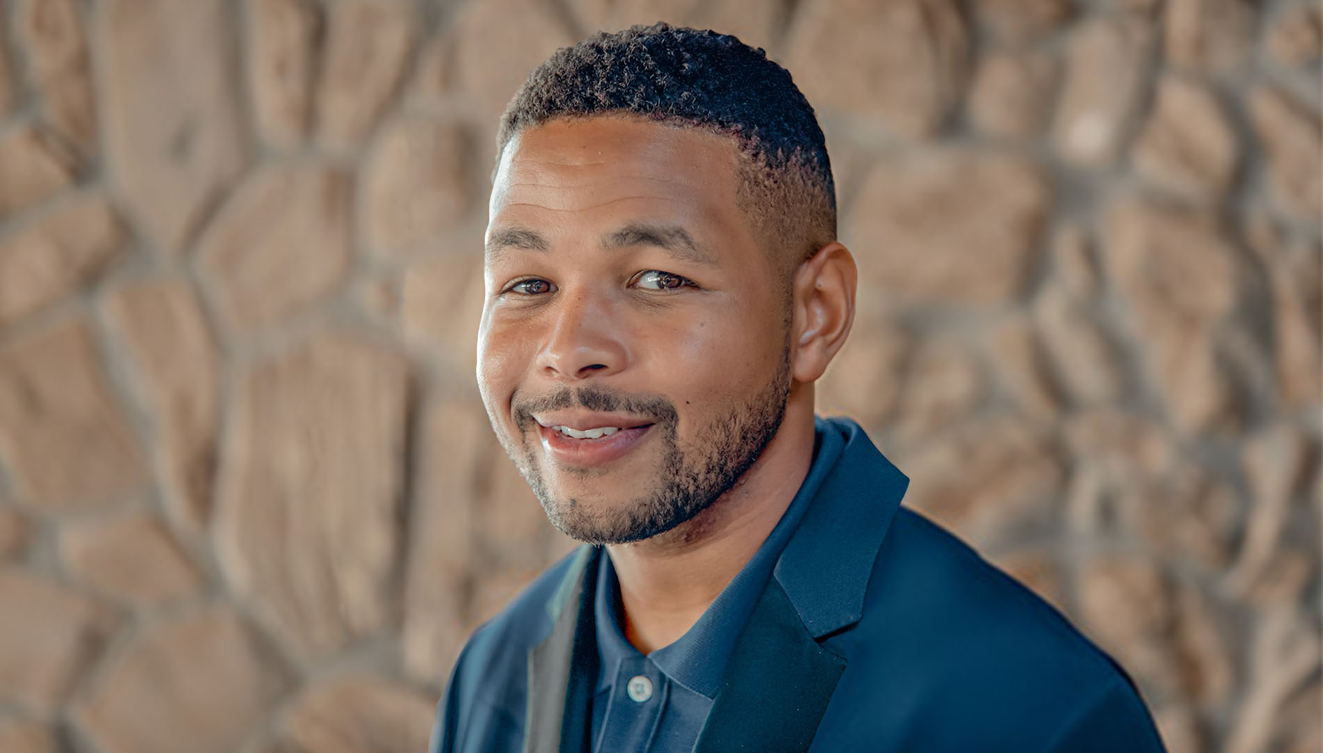 Inky Johnson in front of a stone wall