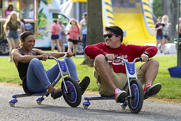 Students riding tricycles