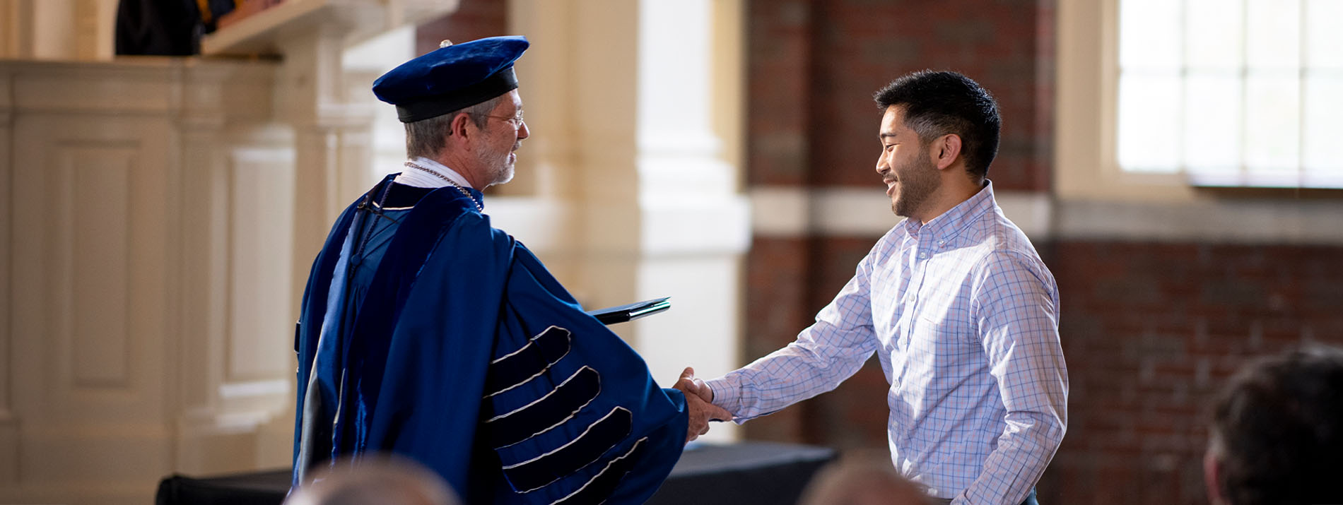 Berry College president shaking hands with award recipient